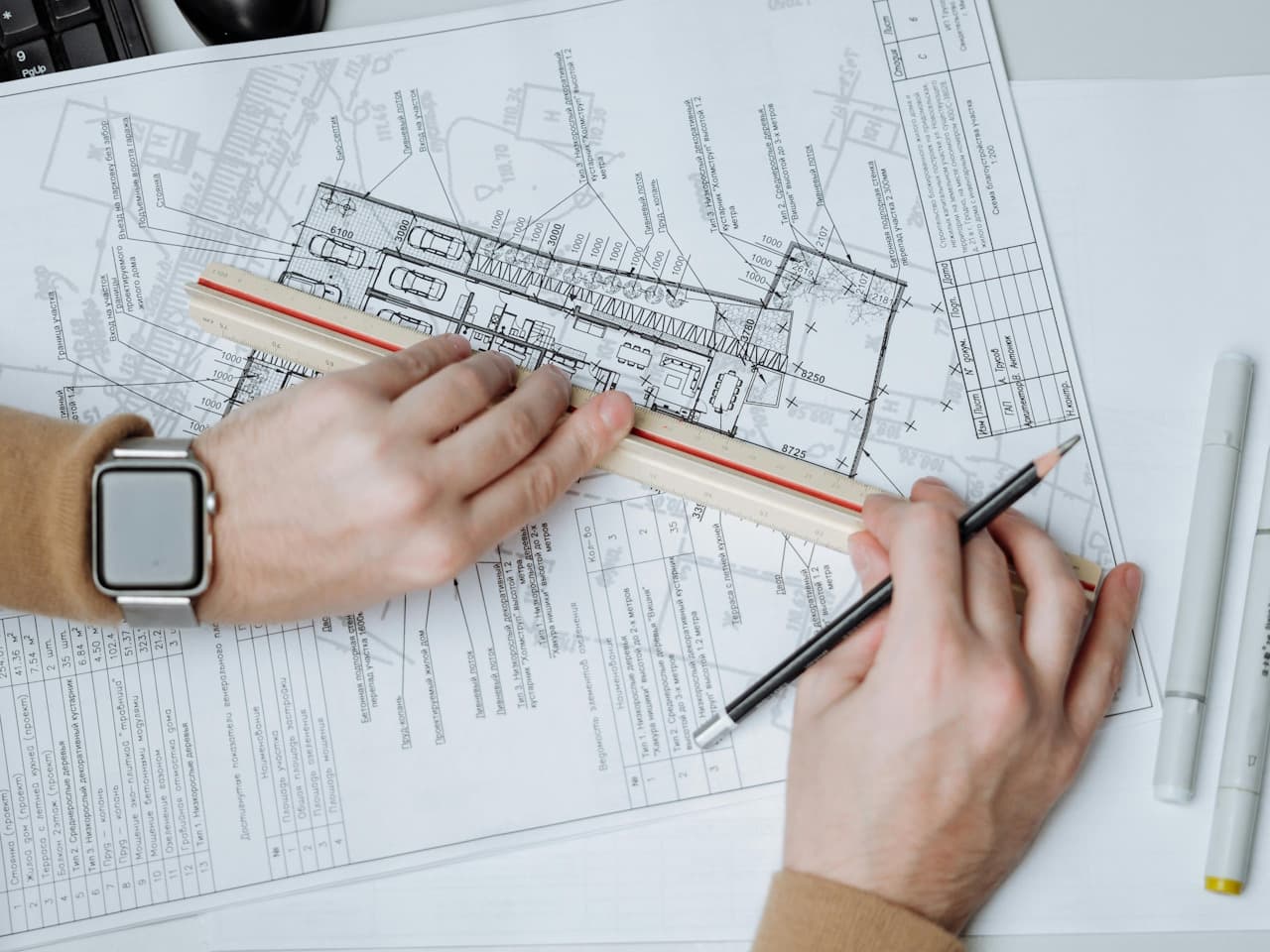 Person planning architectural drawing